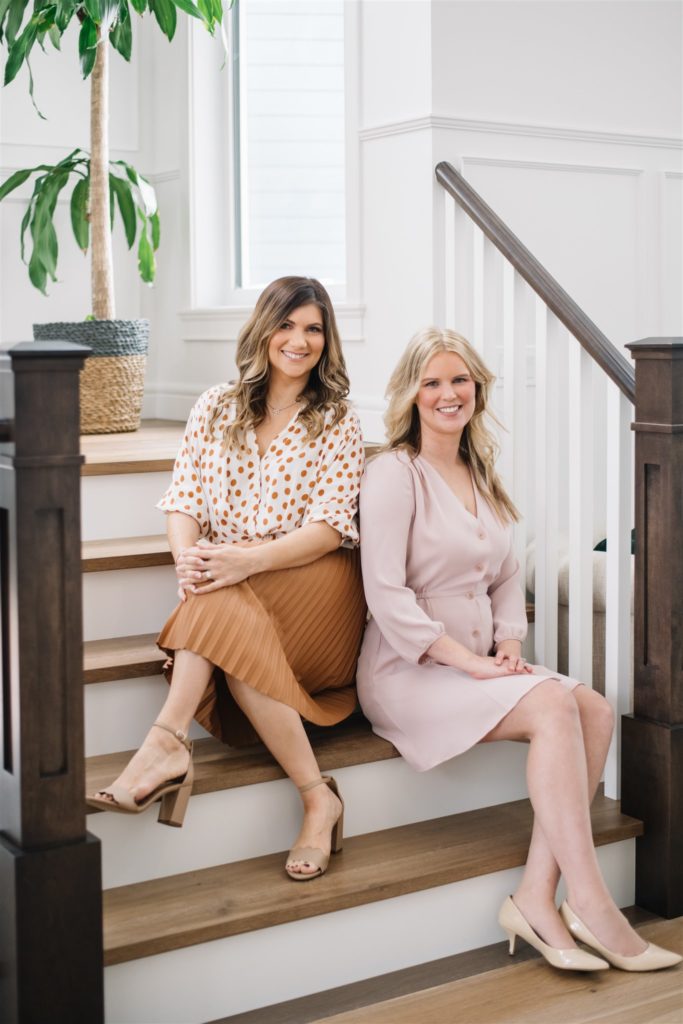 Two women from Edmonton wedding planner Sandra Bettina Events sitting on a staircase