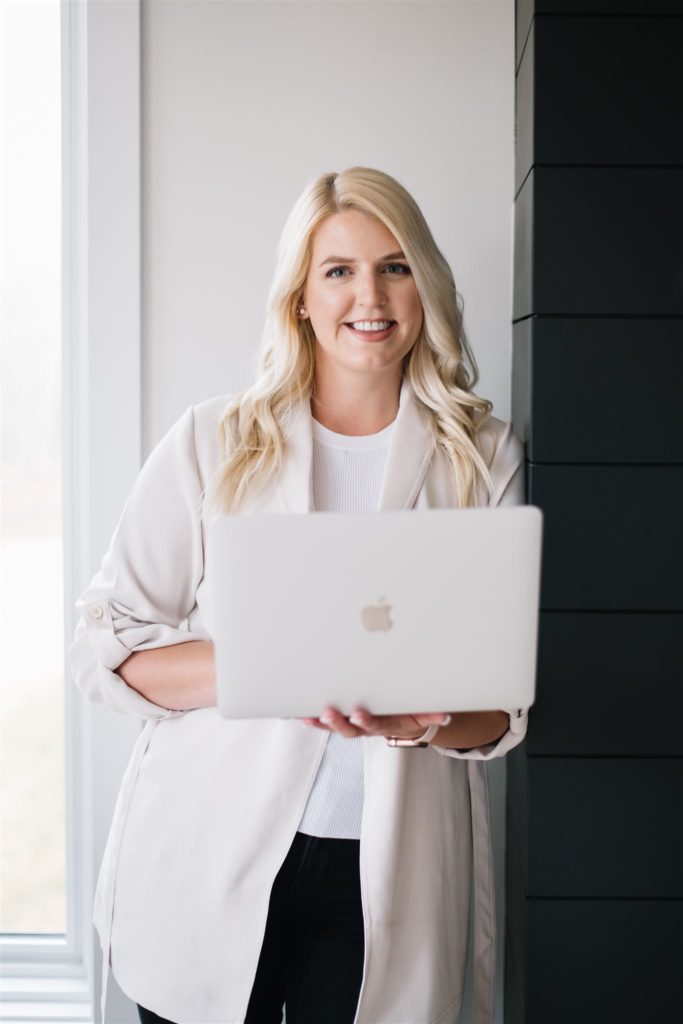 woman learning how to pose with your laptop during a branding photoshoot