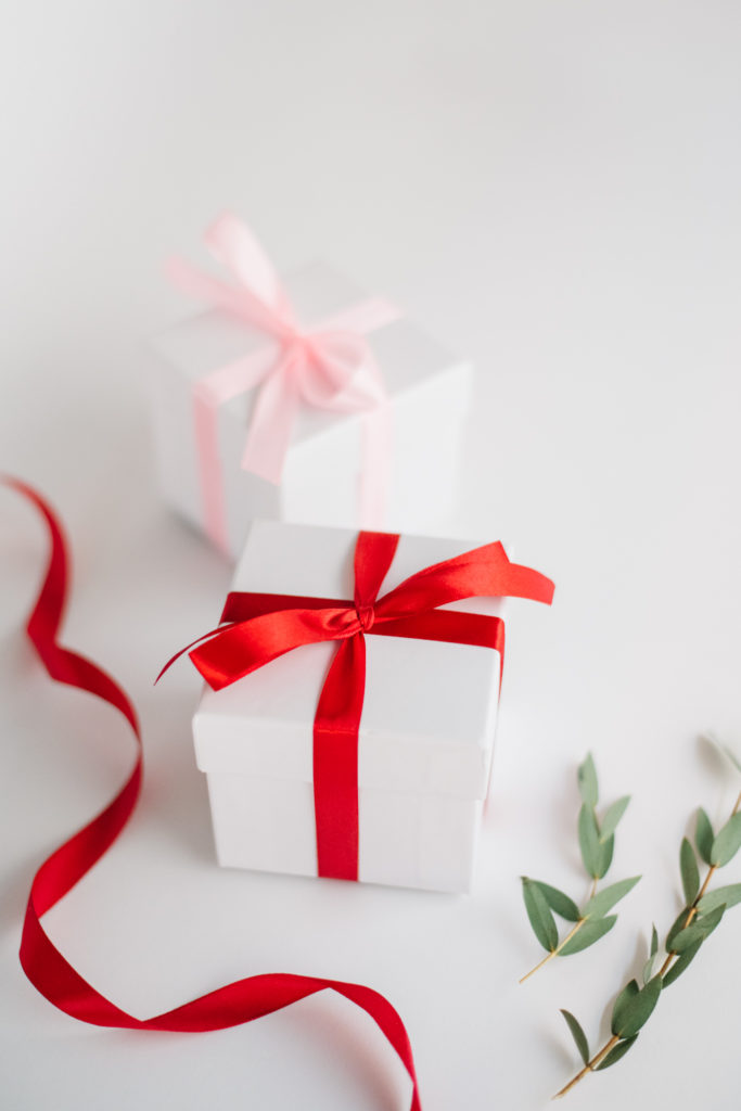 Red ribbon on a white box, creating holiday content